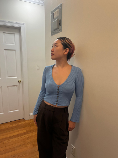 A photo of Allure commerce editor Sarah Han wearing a pair of Sticky Cakes Triangles underneath a blue Vcut top